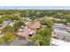 Home featuring a well-kept backyard, a charming brick exterior, mature trees, and a relaxed neighborhood atmosphere at 1363 Cottage Grove Rd, Tarpon Springs, FL 34689