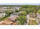 Overhead view showing the home's setting with mature trees, landscaping, and neighborhood context at 1363 Cottage Grove Rd, Tarpon Springs, FL 34689