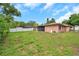 Spacious backyard with lush lawn and privacy fence, perfect for outdoor entertaining and recreation at 1363 Cottage Grove Rd, Tarpon Springs, FL 34689