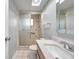 Updated bathroom with tiled shower, new fixtures, and a marble countertop at 1363 Cottage Grove Rd, Tarpon Springs, FL 34689