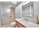 Updated bathroom with tiled shower, new fixtures, and a marble countertop at 1363 Cottage Grove Rd, Tarpon Springs, FL 34689
