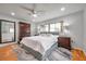 Spacious bedroom featuring hardwood floors, a ceiling fan, and a large bed at 1363 Cottage Grove Rd, Tarpon Springs, FL 34689