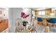Charming dining area features a round glass table and wicker chairs, ideal for casual meals at 1363 Cottage Grove Rd, Tarpon Springs, FL 34689