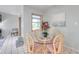 Cozy dining area featuring a round glass table, wicker chairs, and a serene painting at 1363 Cottage Grove Rd, Tarpon Springs, FL 34689