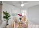 Cozy dining area features a round glass table, seating for four, and views into the adjacent living spaces at 1363 Cottage Grove Rd, Tarpon Springs, FL 34689