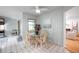 Cozy dining area with a glass table and wicker chairs near the kitchen and sunroom at 1363 Cottage Grove Rd, Tarpon Springs, FL 34689