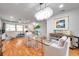 Stylish dining area with a glass table, modern chandelier, and open concept design perfect for entertaining at 1363 Cottage Grove Rd, Tarpon Springs, FL 34689