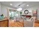 Chic dining room featuring a glass table, modern chandelier, and easy access to the outdoor patio at 1363 Cottage Grove Rd, Tarpon Springs, FL 34689