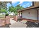 View of the home's front entrance, which features brick pillars with potted plants and stepping stone walkway at 1363 Cottage Grove Rd, Tarpon Springs, FL 34689