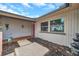 The house's front entrance features a red door and a small tiled porch area with a welcome mat at 1363 Cottage Grove Rd, Tarpon Springs, FL 34689