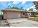 The exterior of the house includes a spacious driveway and an attached two-car garage at 1363 Cottage Grove Rd, Tarpon Springs, FL 34689