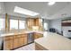 This kitchen features stainless steel appliances, skylight, and eat-in bar area, creating a functional and bright space at 1363 Cottage Grove Rd, Tarpon Springs, FL 34689