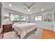 Serene main bedroom features a large bed, three windows offering natural light, and stylish decor at 1363 Cottage Grove Rd, Tarpon Springs, FL 34689