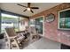 A covered patio featuring comfortable seating with a ceiling fan for warm weather and a view of the yard at 1363 Cottage Grove Rd, Tarpon Springs, FL 34689