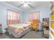 Bright bedroom features a ceiling fan, ample natural light, and a cozy rocking chair at 153 Alpine Ct, Bradenton, FL 34208