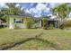 Charming single-story home featuring a well-maintained lawn, landscaping, and a screened entry at 153 Alpine Ct, Bradenton, FL 34208