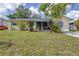 A cozy single-story house with a lush lawn, complemented by lovely landscaping at 153 Alpine Ct, Bradenton, FL 34208