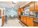 Bright kitchen adjacent to the dining area features wooden cabinets and tile flooring at 153 Alpine Ct, Bradenton, FL 34208