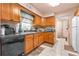 Well-lit kitchen with wooden cabinets, dark countertops, and neutral tile flooring at 153 Alpine Ct, Bradenton, FL 34208