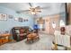 Comfortable living room with a leather sofa, ceiling fan, and carpet flooring at 153 Alpine Ct, Bradenton, FL 34208
