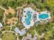 Aerial view of community pool, playground, and surrounding green spaces at 18144 Frame Bnd, Land O Lakes, FL 34638