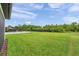 Expansive backyard featuring lush green grass and privacy fence at 18144 Frame Bnd, Land O Lakes, FL 34638