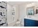 Bathroom features a shark themed shower curtain, vanity with sink and white tiled shower at 18144 Frame Bnd, Land O Lakes, FL 34638