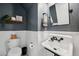 Charming half bathroom with blue walls, white wainscoting, and a vintage-style sink and fixtures at 18144 Frame Bnd, Land O Lakes, FL 34638