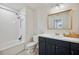 Bright bathroom features a shower-tub combo with matching vanity and plenty of light at 18144 Frame Bnd, Land O Lakes, FL 34638