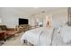 Spacious bedroom with a comfy bed, modern furniture, and a view into the hallway and bathroom at 18144 Frame Bnd, Land O Lakes, FL 34638