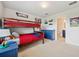 Bedroom features a bunk bed and adjacent bathroom with matching blue vanity and tile flooring at 18144 Frame Bnd, Land O Lakes, FL 34638