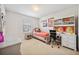Bedroom features a bed, desk, chair, corkboard, and a window with bright, natural light at 18144 Frame Bnd, Land O Lakes, FL 34638
