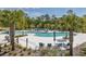 Resort-style pool with ample seating, palm trees and lush landscaping at 18144 Frame Bnd, Land O Lakes, FL 34638