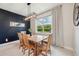 Dining room with wooden table and chairs, large window with beautiful views, and a modern light fixture at 18144 Frame Bnd, Land O Lakes, FL 34638