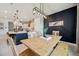 Open dining room with a wooden table, bench and chairs, a stylish light fixture, and access to the kitchen at 18144 Frame Bnd, Land O Lakes, FL 34638