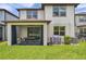 Back of home with covered patio, grill, and spacious backyard at 18144 Frame Bnd, Land O Lakes, FL 34638