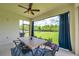 Outdoor patio featuring a dining table, ceiling fan and view of the backyard at 18144 Frame Bnd, Land O Lakes, FL 34638