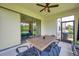 Relaxing covered patio with large sliding door, dining table and ceiling fan at 18144 Frame Bnd, Land O Lakes, FL 34638