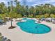 Large freeform community pool featuring a slide and tropical landscaping at 18144 Frame Bnd, Land O Lakes, FL 34638