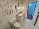 Bathroom featuring a granite vanity top, white tile and wallpaper at 2070 World Parkway Blvd # 36, Clearwater, FL 33763