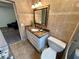 Bathroom with updated vanity, tile floor, and an adjacent toilet at 2070 World Parkway Blvd # 36, Clearwater, FL 33763