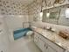 Cozy bathroom featuring a blue tub and granite vanity top at 2070 World Parkway Blvd # 36, Clearwater, FL 33763