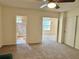 Bedroom with ceiling fan showing entrance to bathroom with tile and shower at 2070 World Parkway Blvd # 36, Clearwater, FL 33763