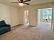 Bedroom area with carpet, partial view of an en suite bathroom, and large windows at 2070 World Parkway Blvd # 36, Clearwater, FL 33763