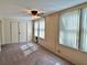 Bedroom with a ceiling fan, two windows and a closet with sliding doors at 2070 World Parkway Blvd # 36, Clearwater, FL 33763