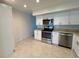 Well-lit kitchen featuring white cabinetry, modern appliances, and tile flooring at 2070 World Parkway Blvd # 36, Clearwater, FL 33763
