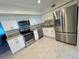 Bright kitchen with stainless steel appliances, tile flooring, and white subway tile backsplash at 2070 World Parkway Blvd # 36, Clearwater, FL 33763