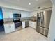 Updated kitchen with white cabinets, stainless steel appliances, and granite countertops at 2070 World Parkway Blvd # 36, Clearwater, FL 33763