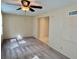 Living room with a ceiling fan, carpet flooring, and access to other rooms at 2070 World Parkway Blvd # 36, Clearwater, FL 33763