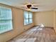 Well-lit living room featuring neutral carpet and window with vertical blinds at 2070 World Parkway Blvd # 36, Clearwater, FL 33763